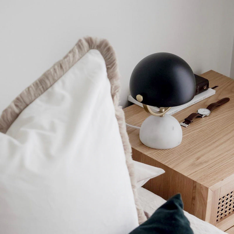Modern Nordic Designer Bedside Nordic-style designer bedside lamp with stone base and matte metal top on minimalist nightstand