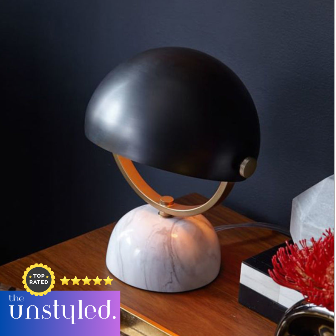 Modern Nordic bedside lamp with stone base and metal shade on wooden side table in living room setting